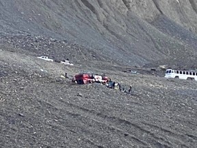 RCMP in Alberta say there are reports that multiple people are injured after a bus, similar to the vehicle pictured, rolled over on a highway that runs between Jasper and Banff National Parks. Responders attend to a rolled-over icefield touring bus in Jasper National Park, Alta., in a handout photo taken Saturday, July 18, 2020. THE CANADIAN PRESS/HO-Randy Cusack