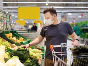 Man in face mask browsing grocery store
