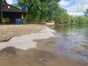 High water and waves at Kelso Beach has eroded the asphalt walking path behind the amphitheatre and deposited 30 centimetres or more of sand and debris photographed Tuesday, July 21, 2020. The city has closed this segment of path. (Scott Dunn/The Sun Times/Postmedia Network)