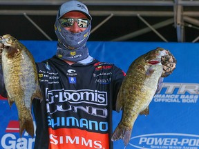 Jeff Gustafson holds up part of his catch at the St. Lawrence River on Day 2 of the Bassmaster Elite Series.