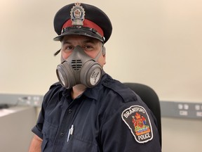 Const. Pat Dietrich demonstrates one of the Brantford Police Service's new N-95 reusable respirator masks.
