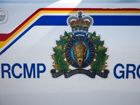 RCMP logo and police cars outside of Calgary on Friday, April 10, 2015.
