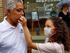 Chloe Hicks, 11, touches her father Selwyn Hick's lip after his beard was shaved off in a hospital foundation fundraiser in Owen Sound, Ont. on Saturday, July 11, 2020. (Scott Dunn/The Sun Times/Postmedia Network)