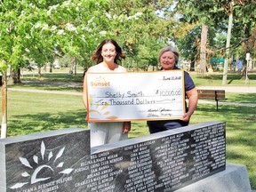 Sunset Palliative Care 50/50 winner Shelby Smith (right) and Executive Director Aldene Moroz pose for a photo in the gardens on Island Park. (supplied photo)