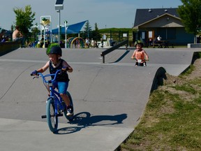 Brothers Ritter, age five, and Axel, three, enjoy the sunshine at the Chinook Winds skate park. Photo by Kelsey Yates