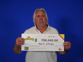 Alan Edmonds displays his $250,000 cheque after picking up his winnings at the OLG prize centre in Toronto. The Picton man, who won with Instant Crossword Deluxe, said he'll likely do "boring stuff" with the money, such as putting new windows in his house.
SUBMITTED PHOTO