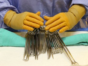 A nurse prepares surgical instruments for use at Belleville General Hospital in 2014. Quinte Health Care's surgical capacity will on Aug. 3 increase to 90 per cent.