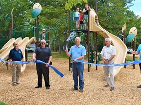 Beleville Mayor Mitch Panciuk, centre, cut the ribbon on the opening day of the new Stanley Park playground with the help of city councillors and staff in the city's east end Thursday. DEREK BALDWIN