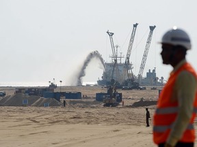 Pumps dredge sand to reclaim land at the site of a Chinese-funded $1.4 billion reclamation just next to Colombos main sea port in January 2018.  AFP/Getty Images