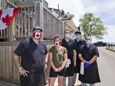 Sandbar on the Beach restaurant owner Stephen Brown (left) his wife Carissa Ayerhart and staff Alexander Newbound (centre) James DeVries and Nick Bridle (right) stand outside the beachfront business at Turkey Point in Norfolk County on Saturday July 4, 2020. Brian Thompson/Brantford Expositor/Postmedia Network