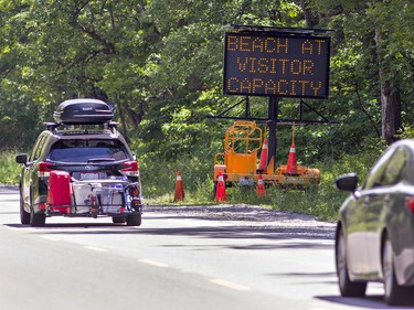 Traffic heads down Turkey Point Road in Norfolk County on Saturday July 4, 2020 despite signs indicating the beach was at capacity for visitors, and no parking was available.