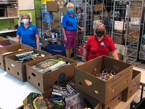 Theresa McDougald (left), Kristine Paul and Pat Lenz, of the Society of St. Vincent de Paul, in the Brant Thrift Store on Wellington Street. The store has introduced a number of public health safety measures to keep their customers and volunteers safe.