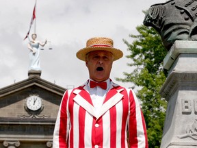 A.J. Benoit keeps a Canada Day tradition alive by singing O Canada next to the bust of Sir Isaac Brock shortly after noon on Wednesday. (RONALD ZAJAC/The Recorder and Times)