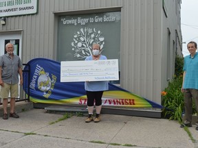 Ed Eby (left) and Tony Dunbar (right) of the Brockville Road Runners Club are joined by Brockville and Area Food Bank manager Theresa Sosnowski in acknowledging the more than $4,000 that the club's Canada Day Run/Walk event on July 1 raised for the food bank.
Tim Ruhnke/The Recorder and Times