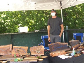 A regular vendor at the Saturday craft market on the King Street Bridge in Gananoque, Ryan Scott was masked and ready to greet customers on Saturday. He and his wife Liv create electrocuted wooden charcuterie boards, bottle openers, coasters and more. They use 2,000 volts of electricity to burn unique designs into the wood, that are then filled with coloured epoxy, for one-of-a-kind effects. Submitted photo