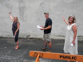 Pam Robertson, chamber executive director, artist Guy Wales and Katherine Hobbs, tourism manager, are in front of the wall that will become a mural. Wayne Lowrie/The Recorder and Times