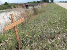 A homemade cross was erected July 29, 2020 near the scene of a deadly crash on the night of July 27, 2020 on Jacob Road. A young girl from Chatham died and her two siblings were injured when a pickup truck landed upside down in a ditch. (Mark Malone/Chatham Daily News)
