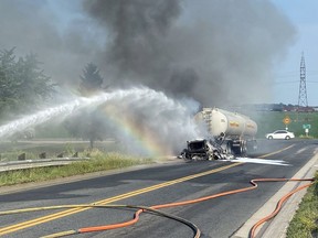 Firefighters extinguish a fire that caused an estimated $480,000 damage to this fuel tanker that caught fire on the Prairie Siding Bridge late Tuesday afternoon. Contributed Photo