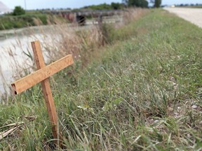 A homemade cross was erected Wednesday near the scene of a deadly crash Monday night on Jacob Road. A seven-year-old girl from Chatham died and her two siblings were injured when a pickup truck landed upside down in a ditch. Mark Malone
