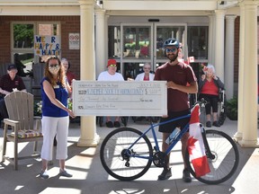 Erin Dale, Community Outreach and Events c-oordinator with Alzheimer Society of Huron County accepts a ceremonial cheque from Connor Adams. Daniel Caudle