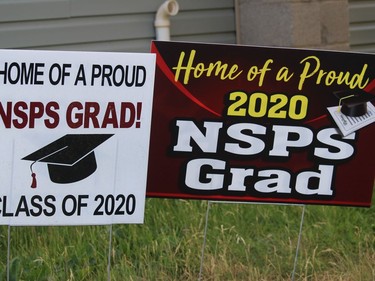 Celebrating graduation from North Stormont P.S., with two signs in Finch. Photo on Friday, July 3, 2020, in Finch, Ont. Todd Hambleton/Cornwall Standard-Freeholder/Postmedia Network