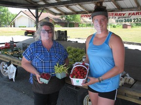 Debbie Henderson (left) and Dallas MacMillan, with some of the products available at the Avonmore Berry Farm stand in Cornwall. Photo on Tuesday, July 7, 2020, in Cornwall, Ont. Todd Hambleton/Cornwall Standard-Freeholder/Postmedia Network