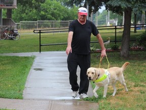 Cornwall's Bruce Wotherspoon, out for a walk on the weekend with his newly-trained guide dog, Stefan. Photo on Saturday, July 11, 2020, in Cornwall, Ont. Todd Hambleton/Cornwall Standard-Freeholder/Postmedia Network