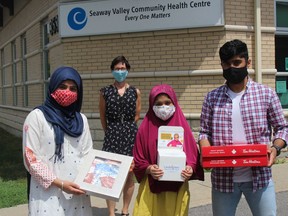 With masks and some treats for Seaway Valley Community Health Centre executive director Debbie St. John-de Wit and staff are the Chaudhry siblings, (from left) Haleema (15), Hafsa (10) and Osama (19). Photo on Tuesday, July 14, 2020, in Cornwall, Ont. Todd Hambleton/Cornwall Standard-Freeholder/Postmedia Network