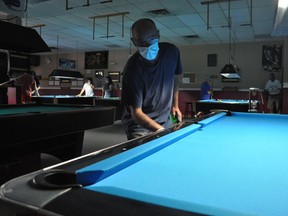 Rack-M-Up Billiards owner Doug Disotell was kept busy on  Friday July 17, 2020 in Cornwall, On, as his business reopened. Here he is seen cleaning one of his pool tables. Francis Racine/Cornwall Standard-Freeholder/Postmedia Network