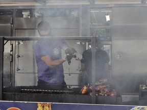 Terry Eaton of Ribs Royale was hard at work on Saturday July 25, 2020 in Cornwall, Ont, during the last day of this year's Ribfest, organized by the Cornwall Optimist Club. Francis Racine/Cornwall Standard-Freeholder/Postmedia Network