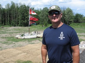 Retired military veteran Gerry Orlando, in front of what's been a labour of love for him, a stone base monument for the Canadian flag he proudly displays. Photo on Wednesday, July 29, 2020, in Cornwall, Ont. Todd Hambleton/Cornwall Standard-Freeholder/Postmedia Network