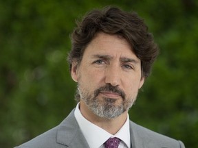 Prime Minister Justin Trudeau looks at a reporter as he listens to a question during a news conference outside Rideau Cottage in Ottawa, Monday, June 29, 2020.