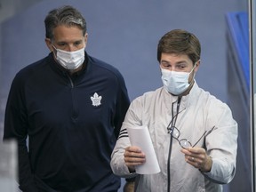 Team president Brendan Shanahan (left) and general manager Kyle Dubas take in a practice during training camp. Dubas figures the Maple Leafs' defensive problems are a "mindset thing and not a skill thing."
