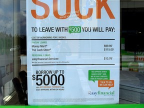 An anti-payday loans sign in Edmonton. New data had shown that eight percent of single parents in Canada borrow money at criminal interest rates.