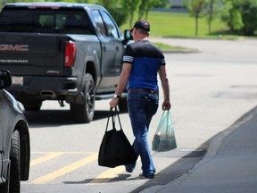 A man leaves the Independent grocery store in Fort McMurray with one reusable bag and one plastic bag on Thursday, July 2, 2020. Laura Beamish/Fort McMurray Today/Postmedia Network