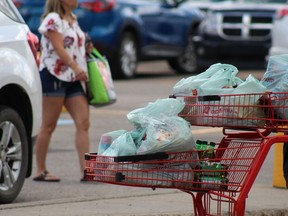 Items are carried out in plastic bags at Joly's Your Independent Grocer in Fort McMurray on Thursday, July 2, 2020. Laura Beamish/Fort McMurray Today/Postmedia Network