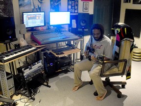 Lyndon John X sits in his Brussels home on July 3 which doubles as his music production area. Daniel Caudle