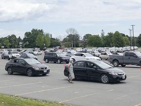 Vehicles were lined up in the St. Lawrence College parking lot and along Portsmouth Avenue for people to get tested for COVID-19 at a drive-through assessment centre set up at the college on Wednesday. (Julia McKay/The Whig-Standard)