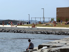 Visitor to Breakwater Park and Gord Downie Pier soak up some sun during the early part of the current heat wave. (Meghan Balogh/The Whig-Standard)