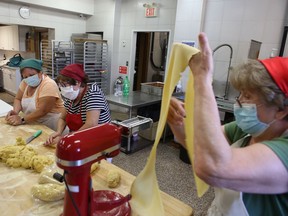 Maria Nuvoloni, right, Lina Venditti, centre, and Assent Gallinaro prepare pasta for takeout at the Italo-Canadian Club of Kingston on Friday. (Elliot Ferguson/The Whig-Standard)
