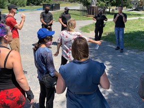 Belle Park campers and housing advocates confront city bylaw officers after an eviction notice was issued for homeless people living at the park in Kingston, Ont. on Tuesday, July 28, 2020. 
Elliot Ferguson/The Whig-Standard/Postmedia Network