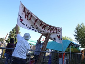 Housing advocates raise a banner calling for no evictions at Belle Park in Kingston, Ont. on Friday, July 31, 2020. Elliot Ferguson/The Whig-Standard/Postmedia Network