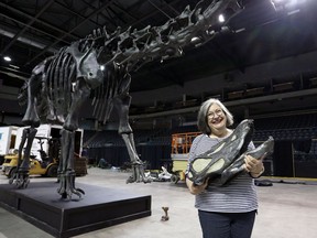 Lynda Colgan, co-organizer of Science Rendezvous in Kingston, holds the head of "Dippy" the diplodocus, the centrepiece of Science Rendezvous 2019.