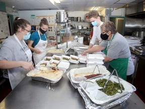 Martha's Table staff, from left, Reanna King, Jersey Phin, Gavin Lalande and Betty Ann Revelle, prepare takeout meals donated by Sienna Senior Living on Thursday. (Ian MacAlpine/The Whig-Standard)