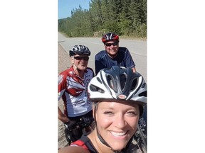 Linda St. Cyr, co-founder and director of the South Temiskaming Active Travel Organization, is among many area residents mourning two cyclists killed in a crash involving a transit bus Wednesday in New Liskeard. St. Cyr posted this photo on her Facebook page of herself with the two men, Jeffrey Splinter, 57, of Sault Ste. Marie, and Garnett Johnson, 74, of Temiskaming Shores. Linda St Cyr/Facebook