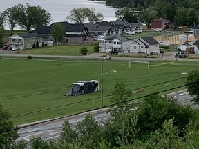 A public transit bus sits sealed in a soccer field on Lakeshore Road in New Liskeard near the scene where two cyclists were struck and killed Wednesday afternoon around 2 p.m. The names of the victims have not yet been released.