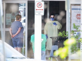 People wait outside the Carling Heights Optimist Community Centre COVID-19 assessment centre in London on Tuesday May 26, 2020. (Derek Ruttan/The London Free Press)