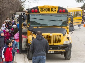 Hundreds of school aged children board buses or walk home with parents from Eagle Heights public school in London. (Free Press file photo)