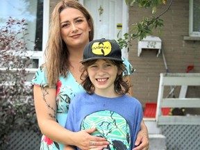 Taylor Lashbrooke-Etches and her son, Jayce, 8, stand outside their family home in North Bay. 
Mackenize Casalino Photo