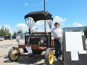 Dennis Boe, of Tisdale, shows the horseless carriage preserved by his father who has passed away. Boe wanted to preserve the family tradition and trailered the unit to Nipawin for a car show as it only drives four milers per hour. Photo Susan McNeil.